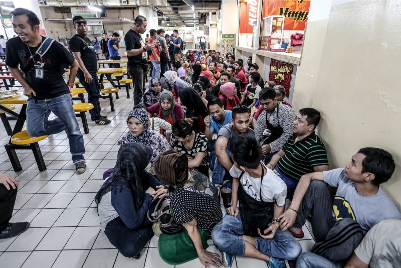 Foreign workers without documentation rounded up in the food court. u00e2u20acu201d Picture by Hari Anggara