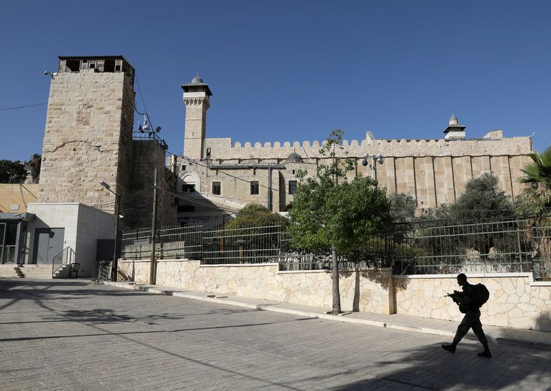 An Israeli soldier walks past Ibrahimi Mosque, which Jews call the Jewish Tomb of the Patriarchs, in the West Bank city of Hebron July 7, 2017. u00e2u20acu201d Reuters pic