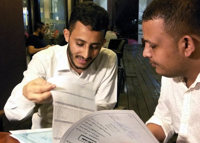 Yemeni Rafek Ahmed Mohammed Al-Sanani (right) and Abdel Rahman Zaid look through documents as they speak with Reuters in Serdang, on the outskirts of Kuala Lumpur, July 20, 2017. u00e2u20acu201d Reuters pic 