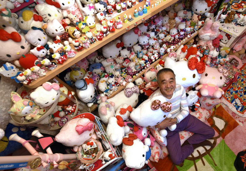 This photo taken on June 28, 2017 shows retired Japanese police officer Masao Gunji posing with his Hello Kitty collection at his pink-painted Hello Kitty house in Yotsukaido, Chiba prefecture. u00e2u20acu201d AFP pic
