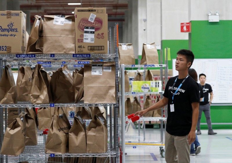 Employees work at Amazon's Prime Now fulfillment centre in Singapore July 27, 2017. u00e2u20acu2022 Reuters pic
