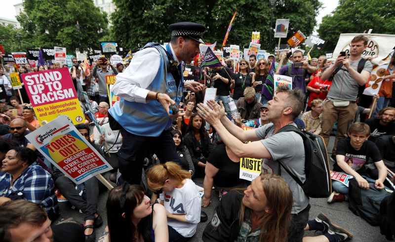 A police officer tells demonstrators to move during a sit-down protest outside Downing Street at an anti-austerity rally and march organised by campaigners Peoples' Assembly, in central London, Britain July 1, 2017. u00e2u20acu201d Reuters pic