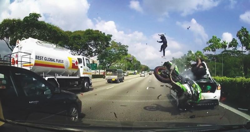 Danny and Trivikram go airborne after their motorcycle crashed into a stalled car on Seletar Expressway near Woodlands Checkpoint. 