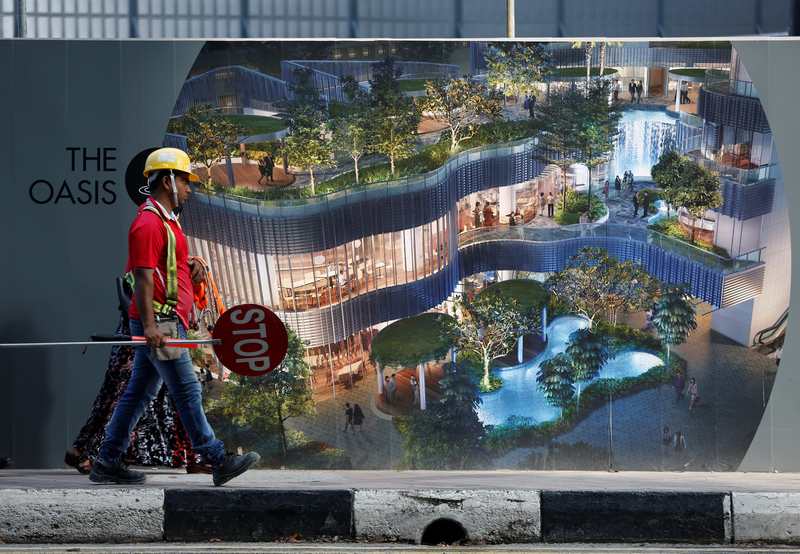 A construction worker walks past a temporary wall at a construction site in Singapore June 28, 2017. u00e2u20acu201d Reuters pic 