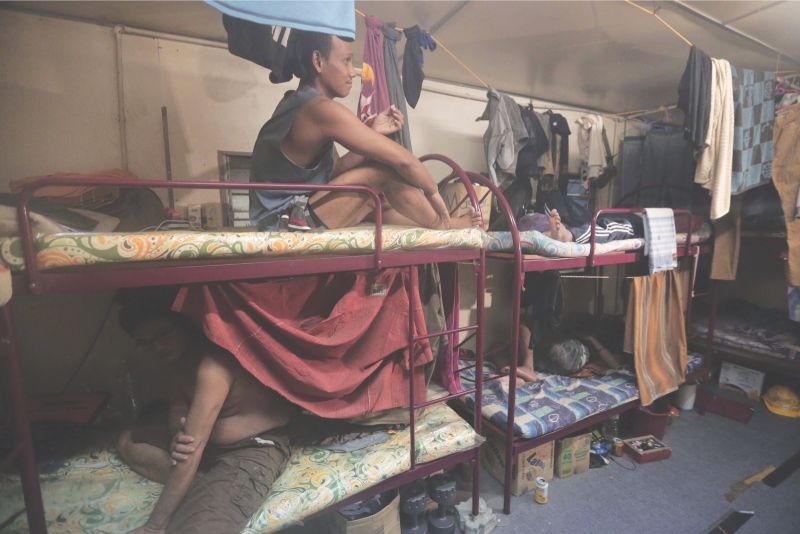 Workers sleep on double-decker beds in containers at the Central Labour Quarters in Dengkil.  u00e2u20acu201d Pictures by Azinuddin Ghazali