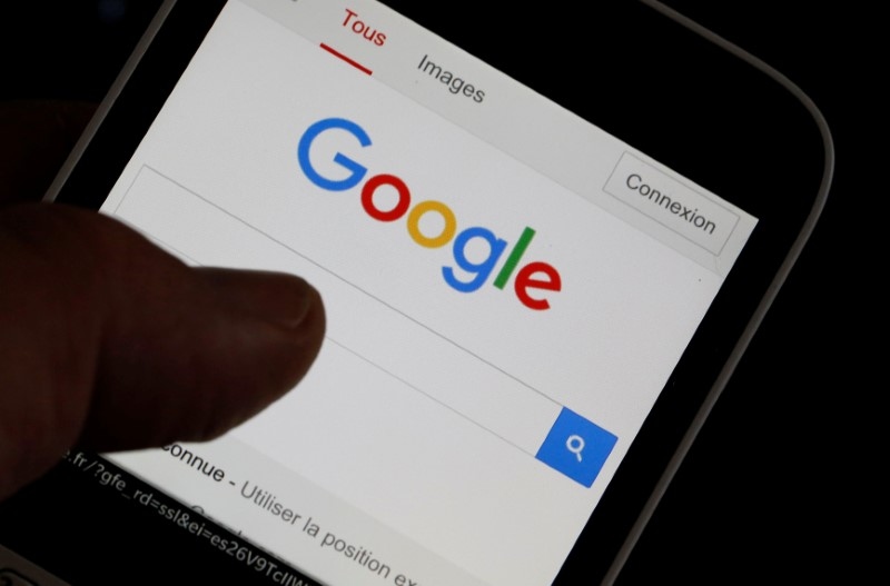 A man holds his smartphone which displays the Google home page, in this picture illustration taken in Bordeaux, Southwestern France August 22, 2016. u00e2u20acu201d Reuters pic