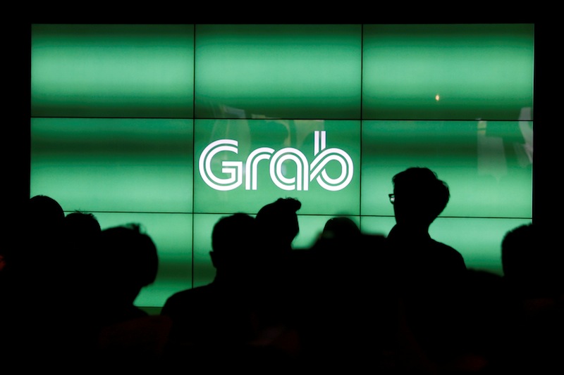 People wait for the start of ride-hailing company Grab's fifth anniversary news conference in Singapore June 6, 2017. u00e2u20acu201d Reuters pic