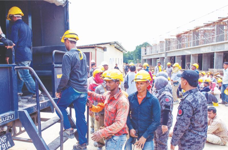 Illegal workers detained during an operation in Kampung Badang, Kota Baru, Kelantan,  yesterday. — Bernama pic
