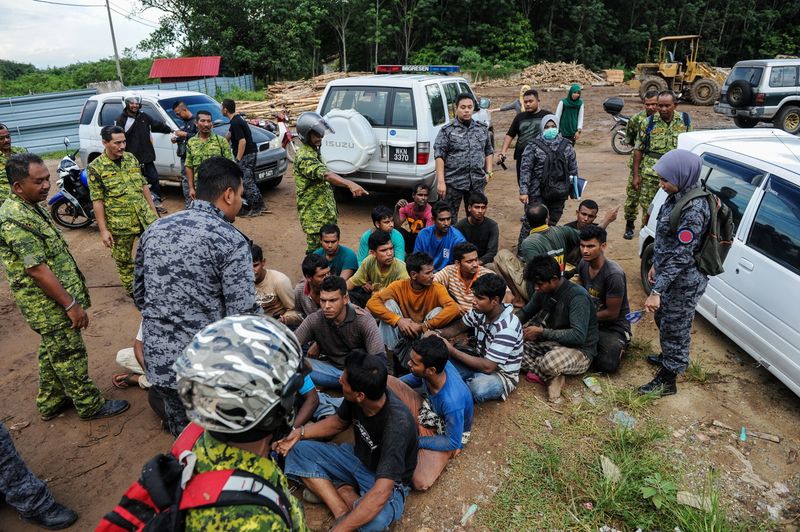RELA and Immigration officers detain illegal immigrants during a raid at a construction site in Kuala Nerang, July 5, 2017. u00e2u20acu201d Bernama pic