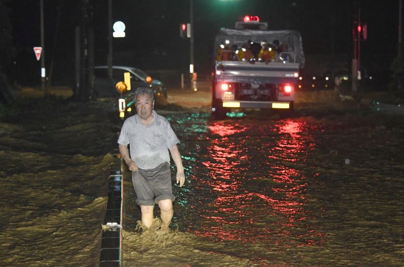 A man walks through a flooded street in Asakura, Fukuoka Prefecture in Japan. u00e2u20acu2022 Reuters pic