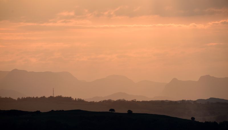 This file photo taken on June 4, 2015 shows the sun setting over the fells of the Lake District, seen from the village of Old Hutton, north west England. u00e2u20acu201d AFP pic