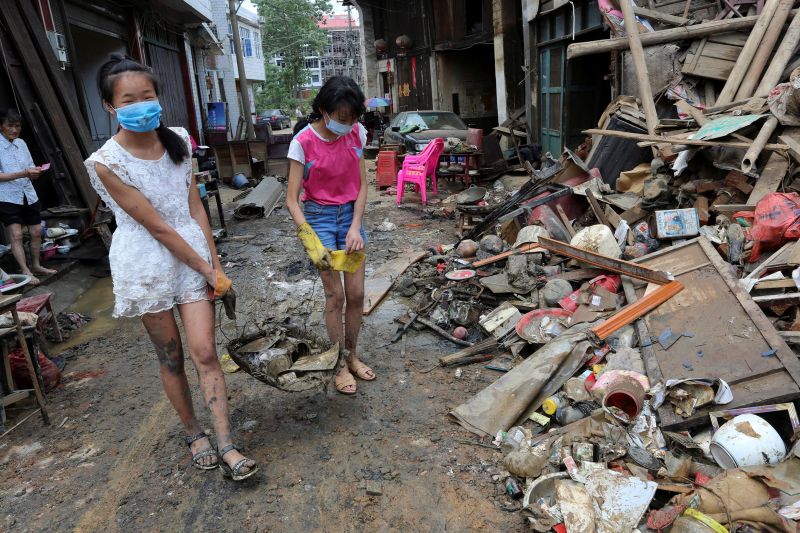 People remove items from mud after a flood at Qiaotouhe town in Lianyuan, Hunan province, China, July 4, 2017. u00e2u20acu201d Reuters pic