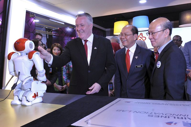 Malaysia Airlines Berhad (MAB) Group Chief Executive Officer Peter Bellew holding a smartphone for identity verification at the launch of Malaysia Airlinesu00e2u20acu2122 First Innovation Laboratory (iSpace) at the Kuala Lumpur International Airport (KLIA), July 27, 