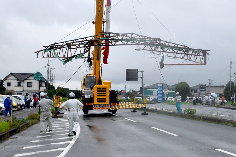 Workers remove a section of roof from the roadside, blown over by strong winds generated by Typhoon Nanmadol in the city of Kumamoto on Kyushu island July 4, 2017. u00e2u20acu201d AFP pic