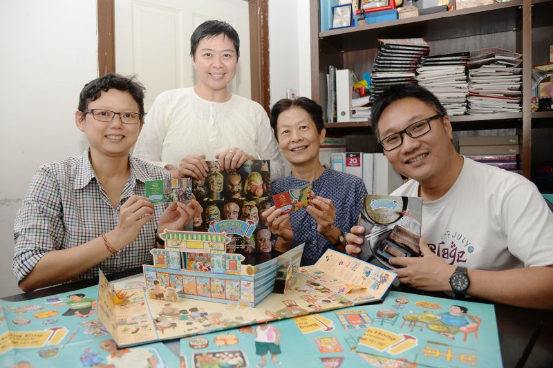 GTWHI general manager Ang Ming Chee (left) and professor Tan Sooi Beng (second from right) pose for a picture with the 'potehi' book set. — Picture by KE Ooi