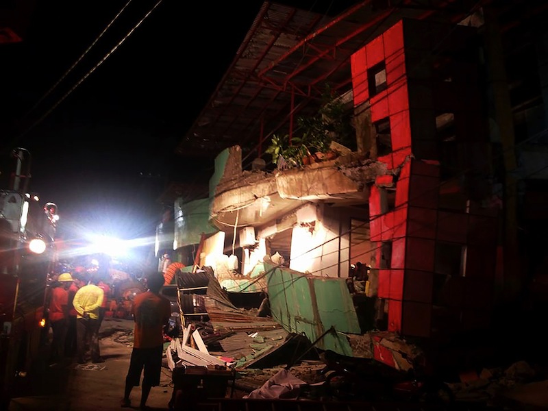 Rescuers stand next to a destroyed building after a 6.5-magnitude earthquake hit the town of Kananga, Leyte province, in central Philippines, on July 6, 2017. u00e2u20acu201du00c2u00a0AFP pic 