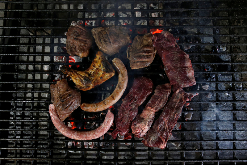 Different kinds of meat are cooked with hot coal at El Paller restaurant in Premia de Mar July 30, 2017. u00e2u20acu201d Reuters pic