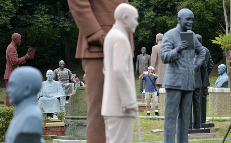 A tourist takes pictures among statues of the late nationalist leader Chiang Kai-shek at a park in Taoyuan, northern Taiwan, August 23, 2017. u00e2u20acu201d AFP pic