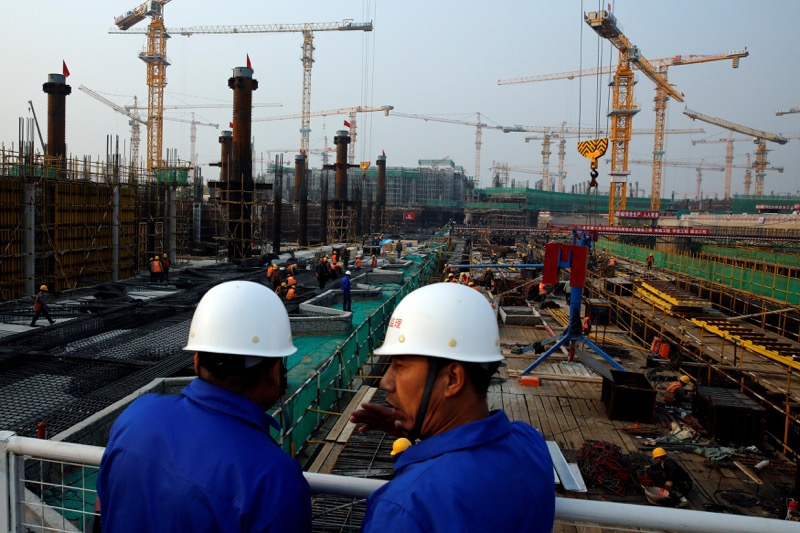 Workers survey the construction site of the terminal for the Beijing New Airport in Beijingu00e2u20acu2122s southern Daxing District, China October 10, 2016. u00e2u20acu2022 Reuters pic