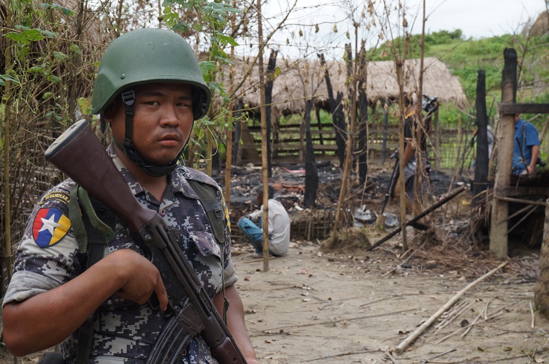 A Myanmar border guard police officer stands guard in front of the remains of a house burned down in a clash between suspected militants and security forces in Tin May village, Buthidaung township, northernu00c2u00a0Rakhineu00c2u00a0state, Myanmar July 14, 2017. u00e2u20acu201d Reut