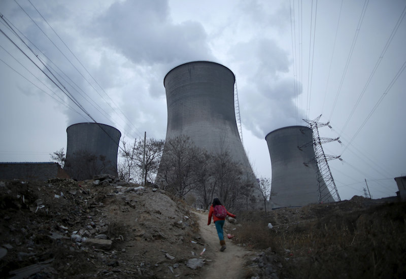 A girl makes her way to her house located next to the cooling towers of a coal-fired power plant in Shijiazhuang, Hebei province, January 28, 2015. u00e2u20acu201d Reuters pic