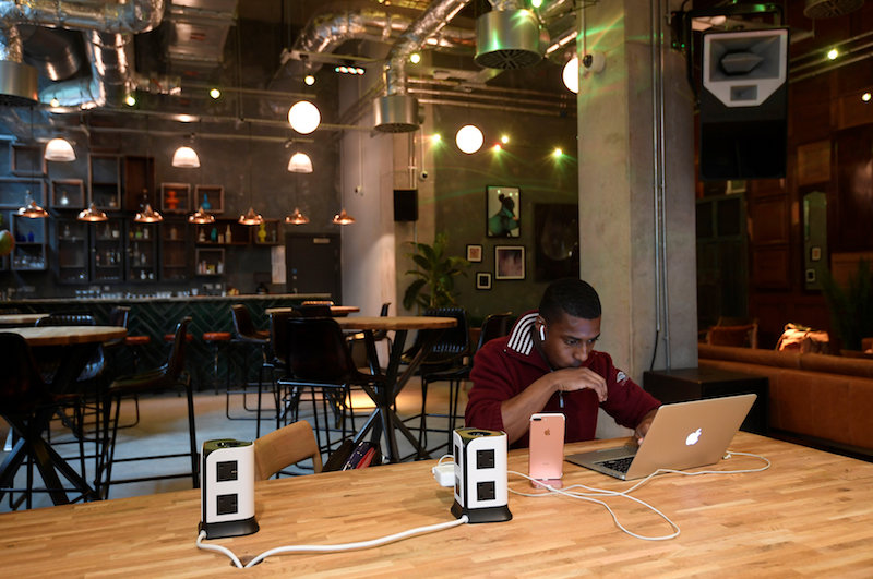 A resident or ‘member’ works at a computer in a shared space at The Collective co-living building in London August 14, 2017. — Reuters pic