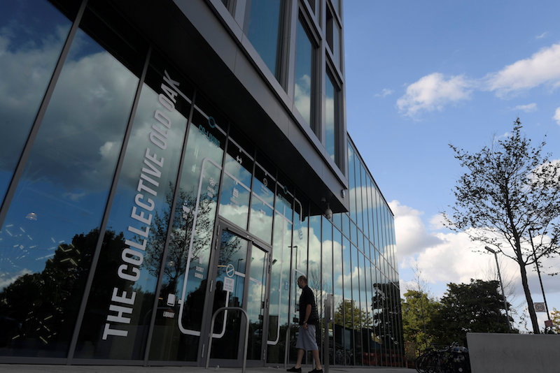 A resident or ‘member’ walks into The Collective co-living building in London August 15, 2017. — Reuters pic
