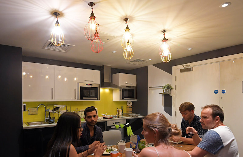 Leaders of start-up businesses eat dinner together in a communal kitchen at The Collective co-living building in London August 15, 2017. — Reuters pic