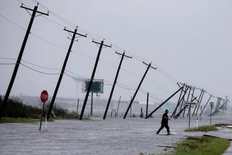 A man walks through floods waters and onto the main road after surveying his property which was hit by Hurricane Harvey in Rockport, Texas, August 26, 2017. u00e2u20acu201d Reuters pic
