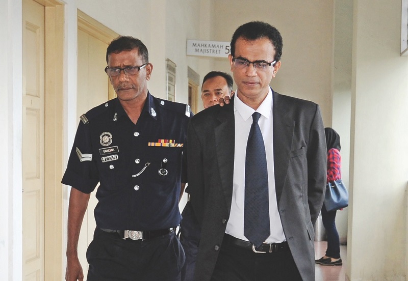 Suayri (right) leaves court to post bail after he was found guilty of uttering death threats against Suraj. u00e2u20acu201d Malay Mail pic