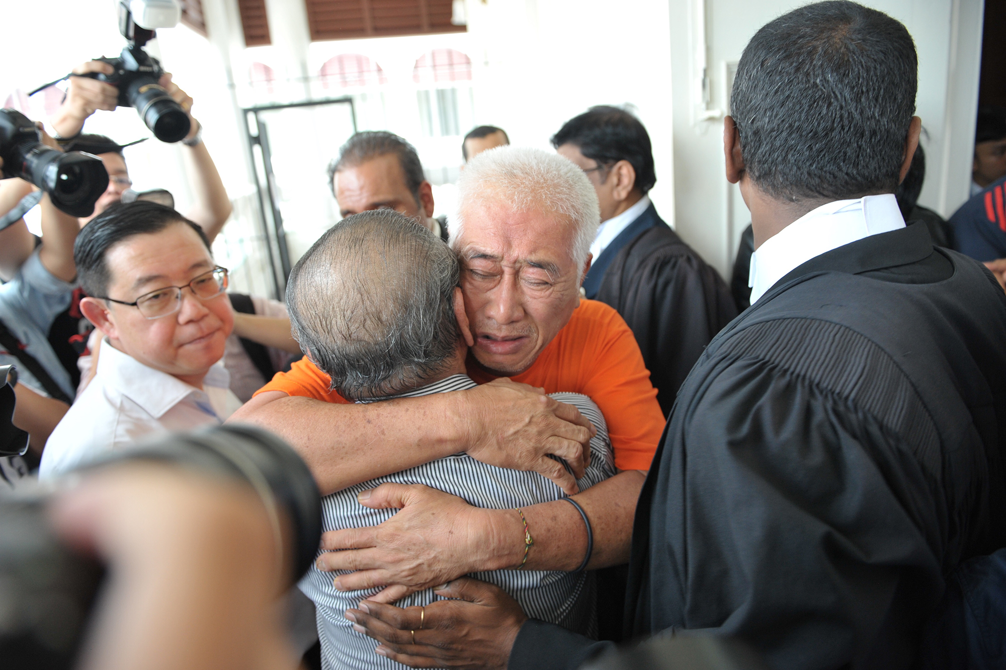 Penang state executive councillor Phee Boon Poh hugs Lim Kit Siang as he is release by the court in George Town August 14, 2017. u00e2u20acu201d Picture by KE Ooi