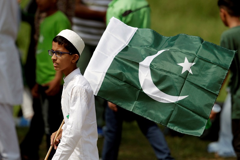 A boy holds a national flag as he watches an air show to celebrate the 70th Independence Day in Islamabad August 14, 2017. u00e2u20acu201d Reuters pic