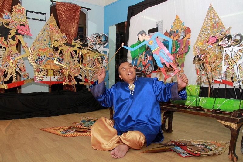 Managing director of Sri Warisan Som Said Performing Arts with a shadow puppet done up as Superman, which he hopes will draw the younger generation to the traditional art. u00e2u20acu201d TODAY pic