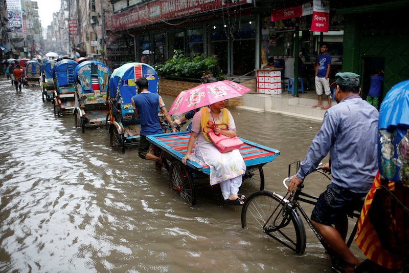 Commuters ride on rickshaws as streets are flooded due to heavy rain in Dhaka, Bangladesh July 25, 2017. u00e2u20acu201d Reuters pic 