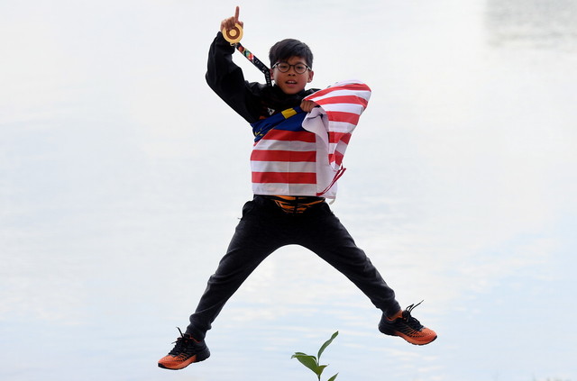 The youngest KL2017 SEA games athlete Adam Hanifah Yoong, 9, shows off the gold medal that he won in the men's water ski tricks event at the Putrajaya Watersports Complex , August 29, 2017. u00e2u20acu201d Bernama pic