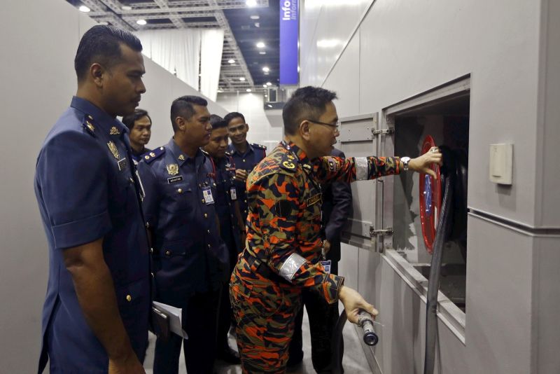 City Fire and Rescue Department director Khirudin Drahman inspecting the a hose reel at the KL Convention Centre. u00e2u20acu2022 Pic by Azneal Ishak