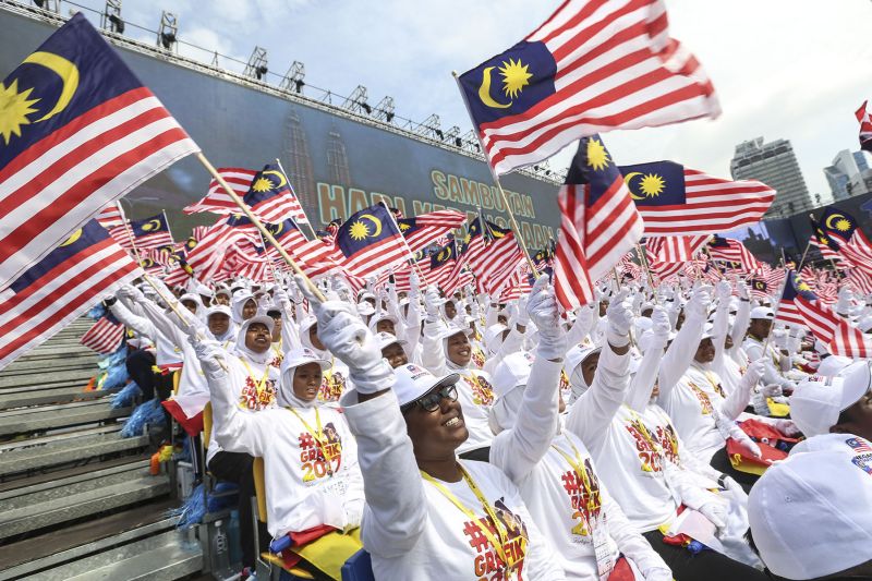 Participants wave the Jalur Gemilang during the 60th National Day parade at Dataran Merdeka in Kuala Lumpur on August 31, 2017. u00e2u20acu2022 Picture by Yusof Mat Isa