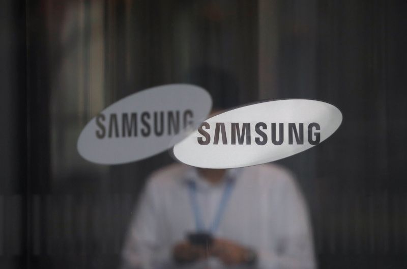 An employee using his mobile phone walks past the logo of Samsung Electronics at its office building in Seoul, South Korea, August 26, 2017. u00e2u20acu201d Reuters pic