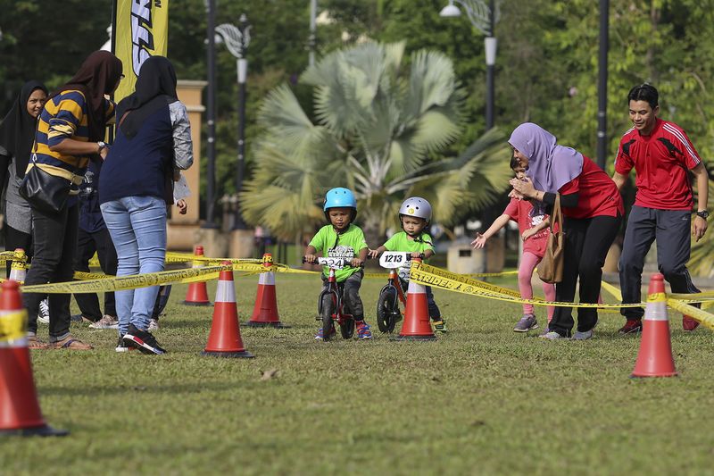 The atmosphere at the balance bike race was friendly, with parents cheering and encouraging the kids along the track.
