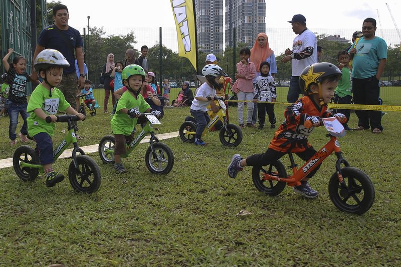 Mohammad Aariz, 2, in orange, racing in the Category 2A of Strider Cup Malaysia.