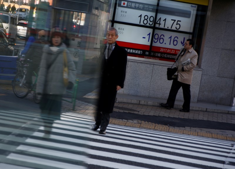 People walk past an electronic board showing stock prices outside a brokerage at a business district in Tokyo, Japan, January 23, 2017. u00e2u20acu201d Reuters pic 