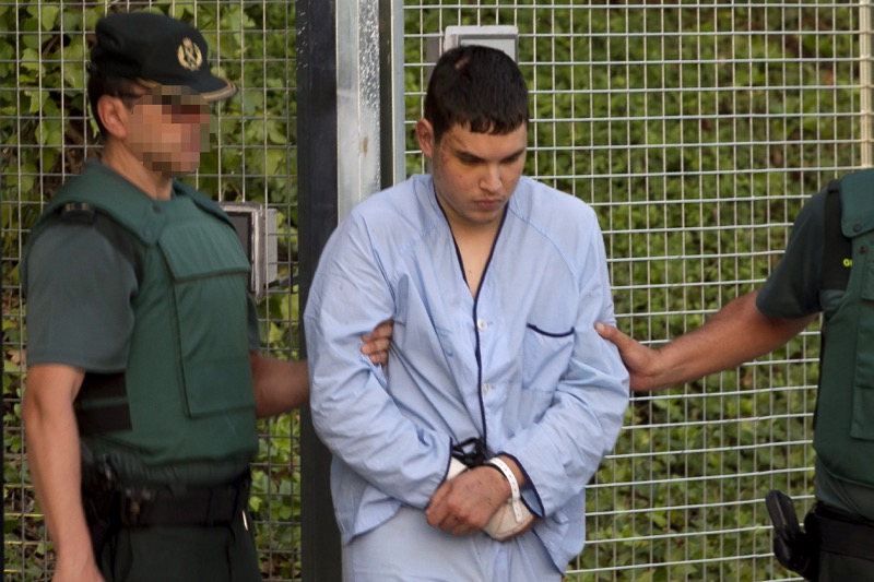 Mohamed Houli Chemlal, suspected of involvement in the terror cell that carried out twin attacks in Spain, is escorted by Spanish Civil Guards from a detention centre in Tres Cantos, near Madrid, on August 22, 2017 before being tranferred to the National 