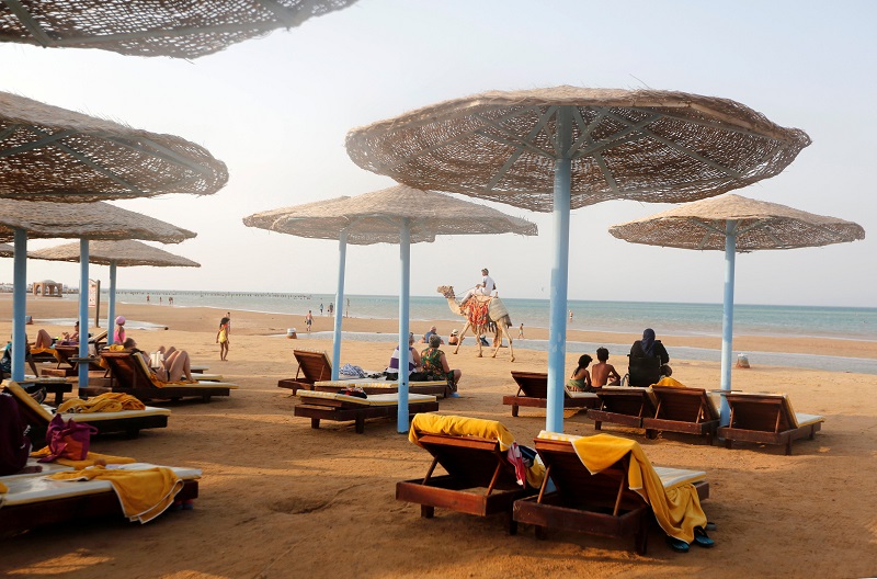 A camel walks in front of tourists and Egyptians on the beach during summer holidays in the Red Sea resort of Hurghada, Egypt, August 28, 2017. u00e2u20acu201d Reuters pic