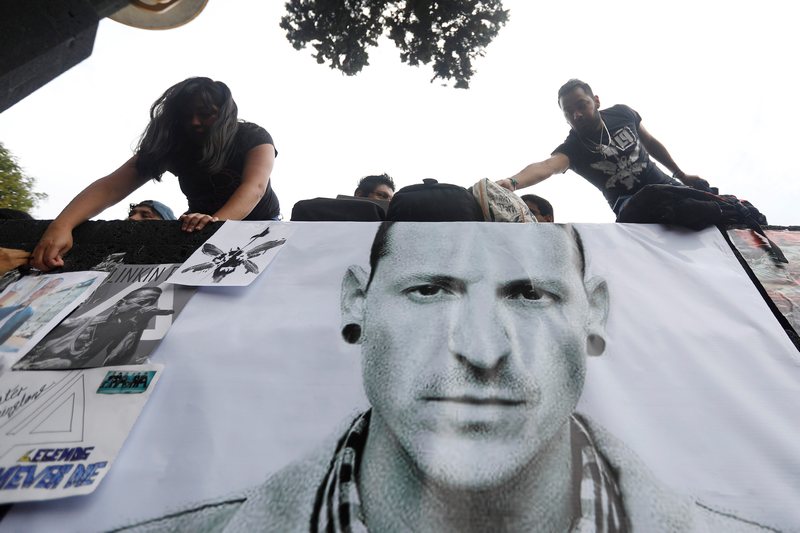 Fans stick posters as they gather at Revolucion monument to pay tribute to Chester Bennington, Linkin Park frontman, following the singer's death by suicide, in Mexico City July 23, 2017. u00e2u20acu201d Reuters pic