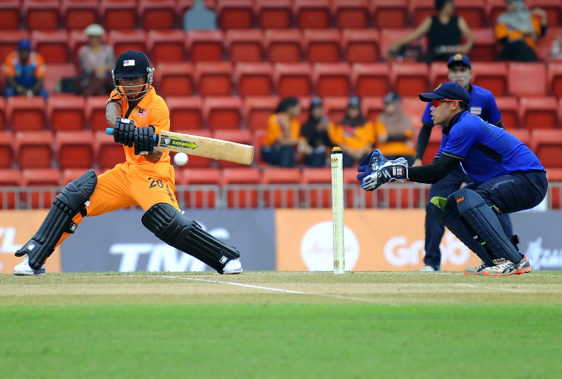 Malaysiau00e2u20acu2122s Mohamad Norwira Zazmie Abdul Halim (right) is about to strike the ball during a cricket match with Thailand at Kinrara Oval in Kuala Lumpur August 18, 2017. u00e2u20acu201d Reuters pic