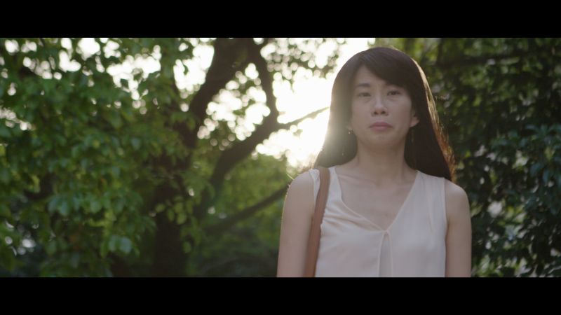 In the video, Cheng is shown looking sadly at a child that reminds her of her separation from her abducted son. — Screen capture via YouTube/Myra Cheng