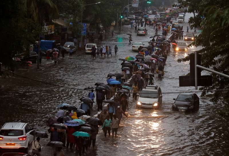 Commuters walk through water-logged roads after rains in Mumbai August 29, 2017. u00e2u20acu201d Reuters pic