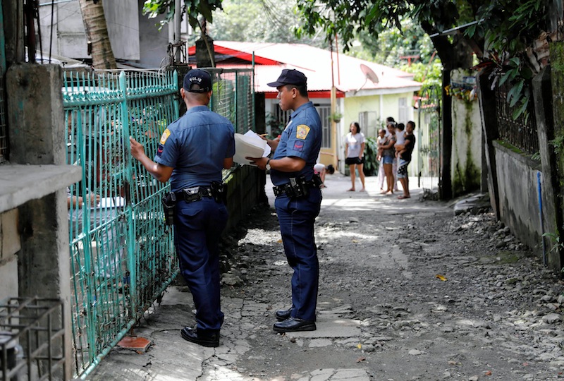 Policemen knock door to door and interview residents during a drug testing operation in Payatas, Quezon City, Metro Manila, Philippines August 23, 2017. u00e2u20acu201d Reuters pic 