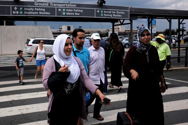 Passengers walk into Washington Dulles International Airport after a federal judge ruled that President Trump's temporary travel ban cannot stop grandparents and other relatives of US citizens from entering the country July 14, 2017. u00e2u20acu201d Reuters pic