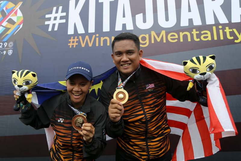 Archery's mixed team compound of Fatin Nurfatehah Mat Salleh (left) and Mohammad Juwaidi Mazuki put Malaysia on a winning start with a third gold medal in the sport. u00e2u20acu201d Picture by Azneal Ishak 